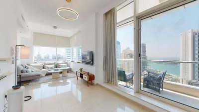 a living room with large windows and a view of the ocean at BR Luxe 1 BDR Apartment w/ Balcony & Sea Views in Dubai