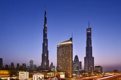 a view of a city skyline at night at Fashion avenue - Formerly Address Dubai Mall Residence in Dubai