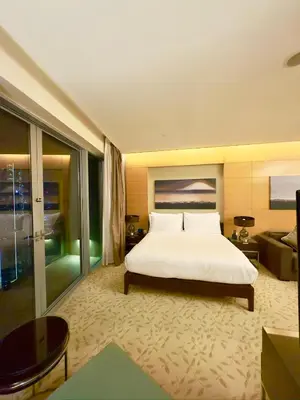 a bedroom with a large white bed and a couch at Fashion avenue - Formerly Address Dubai Mall Residence in Dubai
