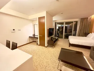a hotel room with a bed and a couch at Fashion avenue - Formerly Address Dubai Mall Residence in Dubai