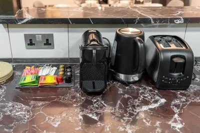a kitchen counter with a coffee maker and a toaster at Ultimate Stay 2BR Sea View at JBR Beach Ain Dubai High Floor Luxury Stay in Dubai