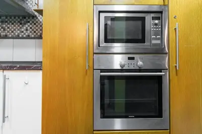 a microwave and a stove in a kitchen at Ultimate Stay 2BR Sea View at JBR Beach Ain Dubai High Floor Luxury Stay in Dubai