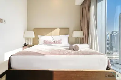 a bedroom with a large bed with two towels on it at Overlooking Marina Canal Views from Living to Bedroom, The Address Residences, Dubai Marina by Deluxe Holiday Homes in Dubai