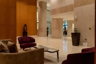 a lobby with a couch and a chair and a table at BellaVista - Exuberant - 1BR - 29 Boulevard - Fountain Views in Dubai