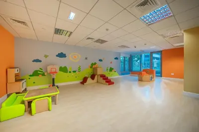 a childrens room with a green and orange wall at BellaVista - Exuberant - 1BR - 29 Boulevard - Fountain Views in Dubai