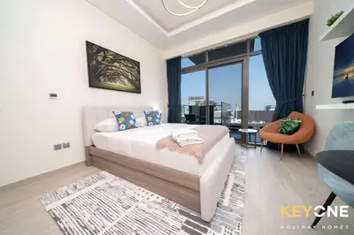 a bedroom with a bed and a large window at Farhad Exclusive Studio Suite in Dubai