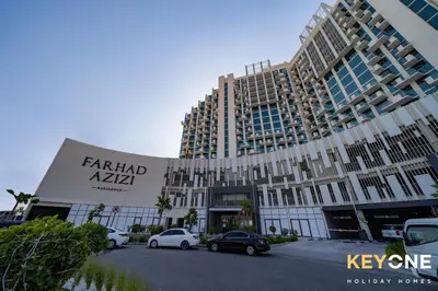 a large building with cars parked in front of it at Farhad Exclusive Studio Suite in Dubai