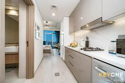 a kitchen with white cabinets and a sink at Farhad Exclusive Studio Suite in Dubai