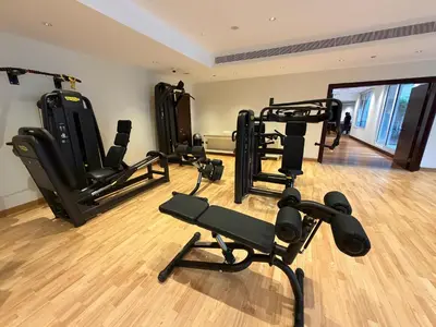 a gym with several exercise equipment in a room at Fully-equppied studio with private beach and pool in Dubai