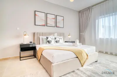 a white bedroom with a large bed and a window at Opulent 1BR at MAG 218 Dubai Marina by Deluxe Holiday Homes in Dubai