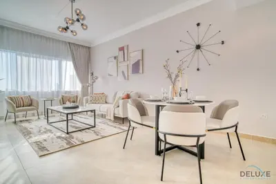 a living room with a table and chairs and a couch at Opulent 1BR at MAG 218 Dubai Marina by Deluxe Holiday Homes in Dubai