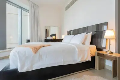 a bedroom with a large bed and a large window at BellaVista - Huge Terrace 1BR Apartment 29 Boulevard Downtown with Burj Khalifa and Fountain Views in Dubai