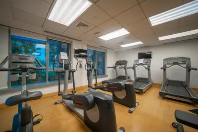 a gym with several tread machines in a room at BellaVista - Huge Terrace 1BR Apartment 29 Boulevard Downtown with Burj Khalifa and Fountain Views in Dubai