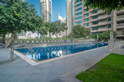 a swimming pool in a city with tall buildings at BellaVista - Huge Terrace 1BR Apartment 29 Boulevard Downtown with Burj Khalifa and Fountain Views in Dubai
