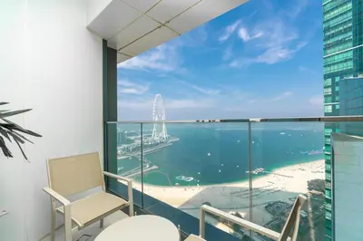 a balcony with a view of the water and a beach at Lux BnB I The Address JBR I Ocean View in Dubai