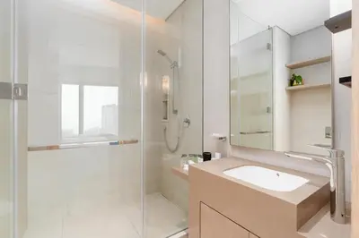 a white bathroom with a sink and a shower at Lux BnB I The Address JBR I Ocean View in Dubai