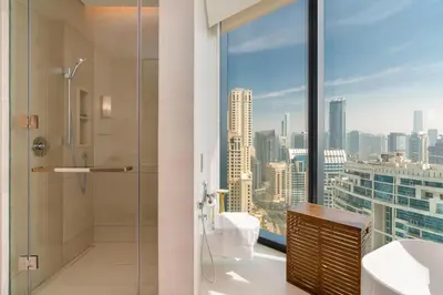 a bathroom with a shower and a view of the city at Lux BnB I The Address JBR I Ocean View in Dubai