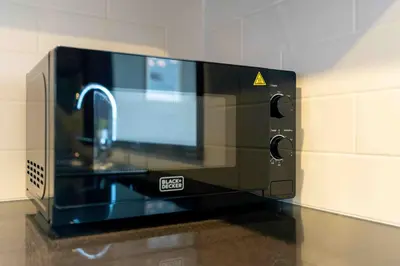 a microwave oven sitting on top of a counter at Lux BnB I 29 Burj BLVD I Downtown Views in Dubai