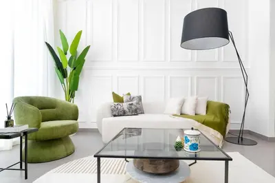 a living room with a couch and a table and a lamp at ON OFF HH- CREEK HARBOUR-Lavish Parisian 2 BR in Dubai