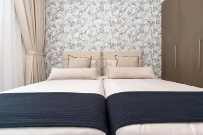 two beds sitting next to each other in a bedroom at ON OFF HH- CREEK HARBOUR-Lavish Parisian 2 BR in Dubai