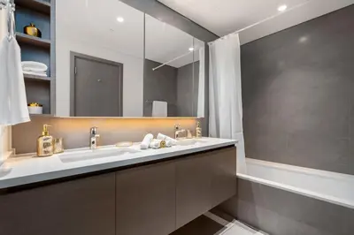 a bathroom with two sinks and a large mirror at ON OFF HH- CREEK HARBOUR-Lavish Parisian 2 BR in Dubai