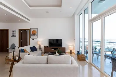 a living room with a white couch and a television at Oceana Residences, The Palm Jumeirah - Mint Stay in Dubai
