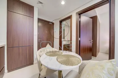 a dining room with a white table and chairs at Modern City Retreat Vera Residence, Business Bay in Dubai