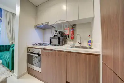 a kitchen with a sink and a stove at Modern City Retreat Vera Residence, Business Bay in Dubai