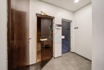 a corridor with a door and a table in a room at Modern City Retreat Vera Residence, Business Bay in Dubai