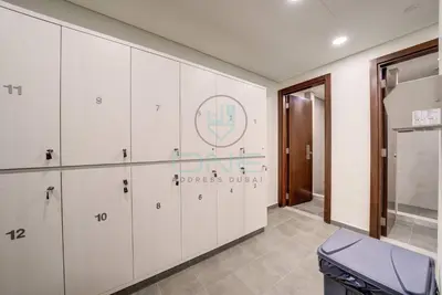 a room with white cabinets and a sign on the wall at Modern City Retreat Vera Residence, Business Bay in Dubai