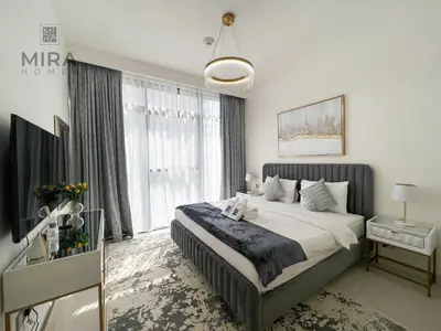 a bedroom with a large bed and a large window at Mira Holiday Homes - Newly 1 bedroom apartment with beach access in Dubai