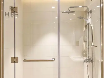 a shower with a glass door next to a sink at Mira Holiday Homes - Newly 1 bedroom apartment with beach access in Dubai