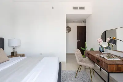 a bedroom with a desk and a bed and a desk and chair at Frank Porter - Bay Central West 2 in Dubai
