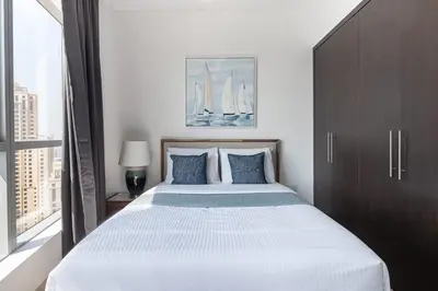 a bedroom with a large white bed with a window at Frank Porter - Bay Central West 2 in Dubai