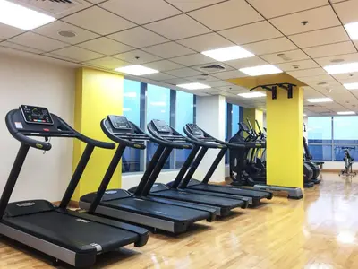 a row of treadmills in a gym at Frank Porter - Bay Central West 2 in Dubai