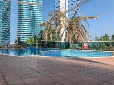 a swimming pool in a city with tall buildings at GuestReady - Chic Studio in Urban JLT in Dubai