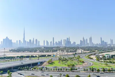 a freeway with a city skyline in the background at Luxury Escapes - Brand New Studio with View - Azizi Farhad Jaddaf in Dubai