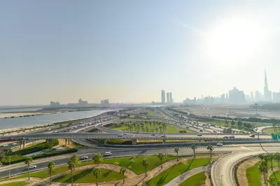 an aerial view of a highway with a city in the background at Luxury Escapes - Brand New Studio with View - Azizi Farhad Jaddaf in Dubai