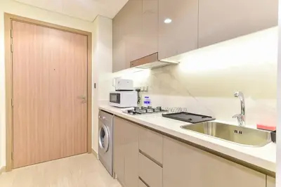 a kitchen with a sink and a dishwasher at Luxury Escapes - Brand New Studio with View - Azizi Farhad Jaddaf in Dubai