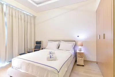 a bedroom with a large bed and a window at Luxury Escapes - Brand New Studio with View - Azizi Farhad Jaddaf in Dubai