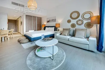 a hotel room with a bed and a living room at LIV Residence Tower, Dubai Marina in Dubai