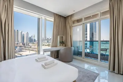 a bedroom with a white bed and a large window at GuestReady - Stylish Galore near Dubai Fountain in Dubai