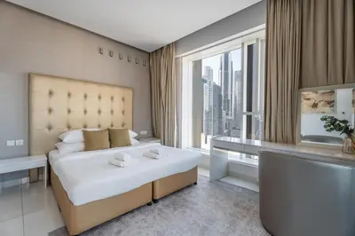 a bedroom with a large bed and a large window at GuestReady - Stylish Galore near Dubai Fountain in Dubai