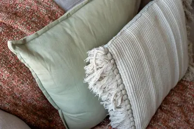 a white pillow sitting on top of a couch at GuestReady - Stylish Galore near Dubai Fountain in Dubai