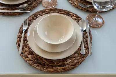 a table set with plates and silverware on a table at GuestReady - Stylish Galore near Dubai Fountain in Dubai