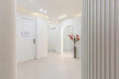 a hallway with a vase with red flowers in it at Horizon Tower - Stunning Four Bedroom in Dubai