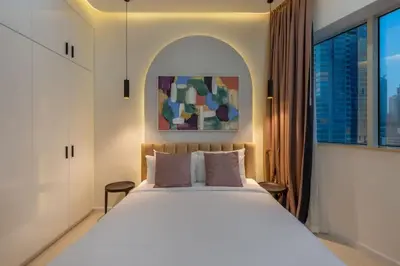 a bedroom with a large white bed and a window at Horizon Tower - Stunning Four Bedroom in Dubai