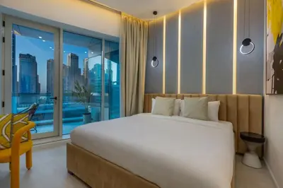 a bedroom with a large bed and a large window at Horizon Tower - Stunning Four Bedroom in Dubai