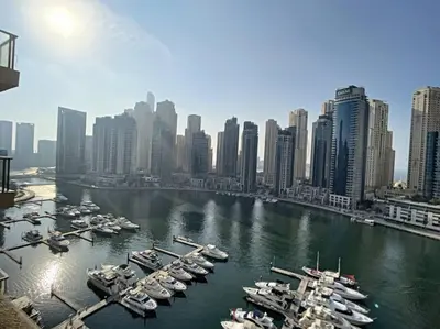 a group of boats docked in a harbor in a city at Al Majara 2 - Gorgeous One Bedroom in Dubai