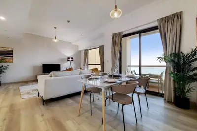 a living room with a table and a couch at Sadaf 6, JBR - Remarkable Two Bedroom in Dubai